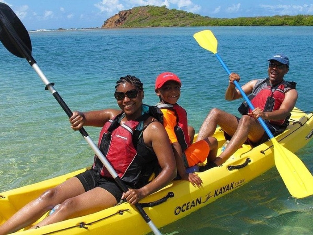 a group of people in a boat on a body of water