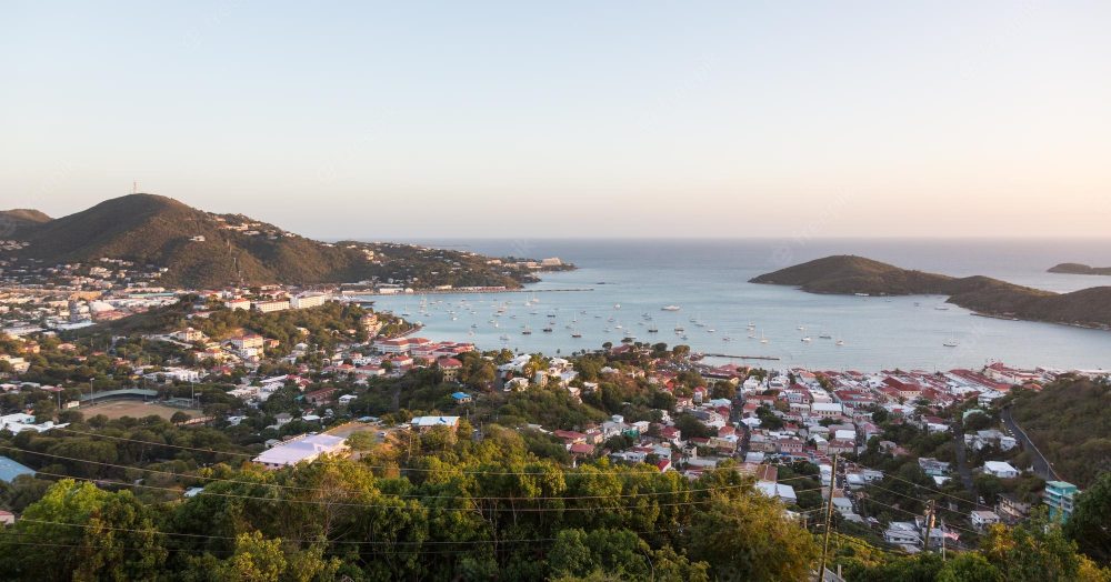 a large body of water with a mountain in the background