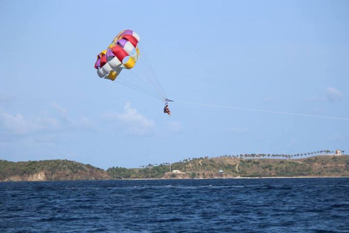 a parachute is flying over a body of water