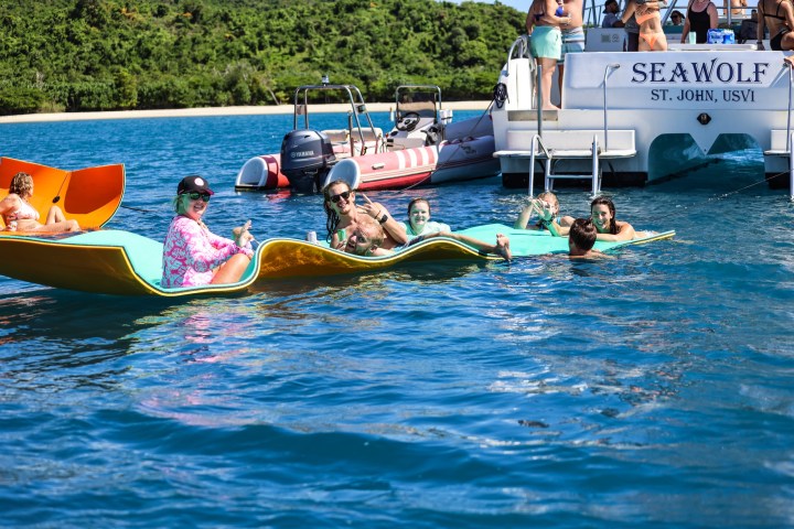 a group of people in a small boat in a body of water