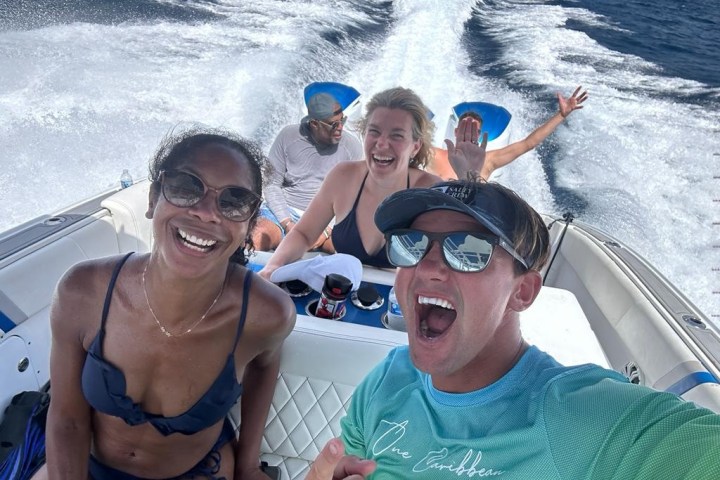 a couple of people that are standing in a body of water