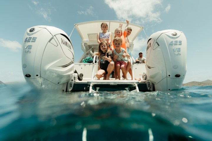 a group of people riding on the back of a boat