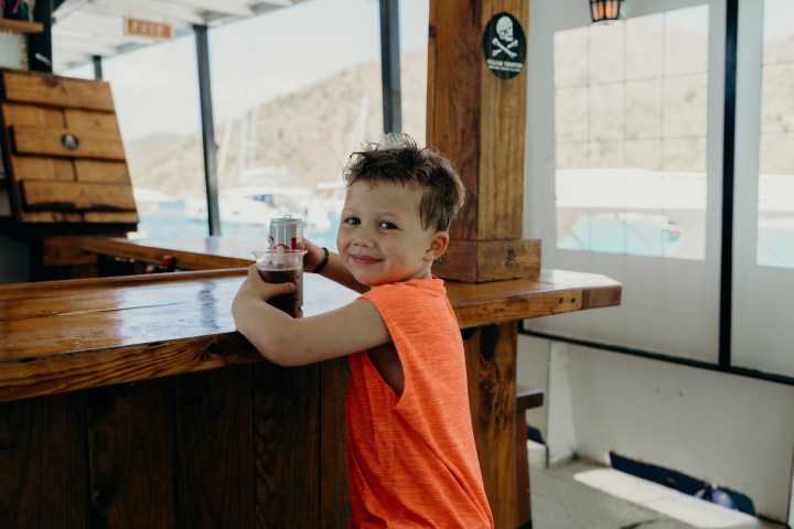 a little boy that is sitting on a table